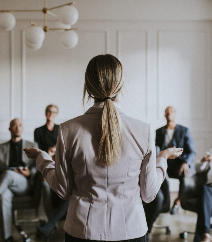 Businesswoman talking in a seminar Businesswoman talking in a seminar